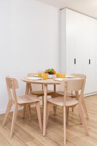a wooden table and chairs in a dining room at Apartamenty Morskie Oko by Renters in Międzyzdroje