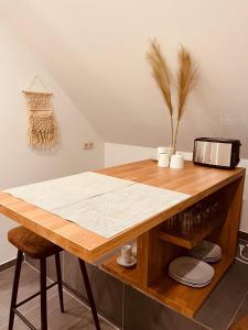 a kitchen with a wooden table with a toaster at Deich Winde 9.2 in Dorum Neufeld