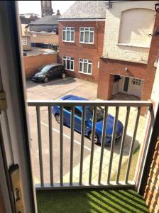 a balcony with a car parked in a parking lot at A Lovely Double Bedroom + Private Bathroom in Kettering