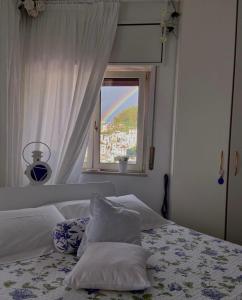 a bedroom with a bed with a window at Casa Blu Cobalto in Maiori