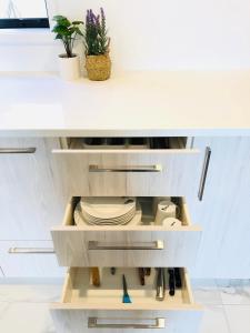 a kitchen with a white counter top with a drawer at Arena,Railway Station Townhouse with Free car park in Christchurch