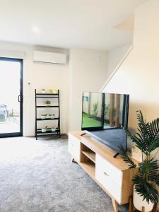 a large living room with a fish tank on a table at Arena,Railway Station Townhouse with Free car park in Christchurch