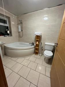 a bathroom with a tub and a toilet and a sink at Private ensuite room in Birmingham in Birmingham