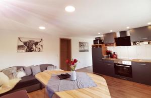 a kitchen and living room with a table in a room at Hartl Hof in Breitenberg