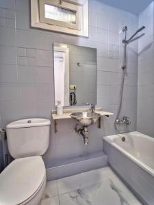 a bathroom with a toilet and a sink and a tub at APARTAMENTO EN GROS, SAN SEBASTIÁN Zurriola Beach in Donostia-San Sebastián +16 photos