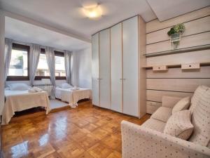 a living room with two beds and a couch at APARTAMENTO EN GROS, SAN SEBASTIÁN Zurriola Beach in Donostia-San Sebastián
