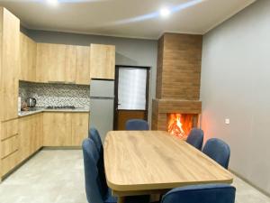 a kitchen with a table and chairs and a fireplace at Star Villa Bakuriani in Bakuriani