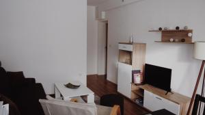 a living room with a couch and a tv at Apartman Barbi in Kupres