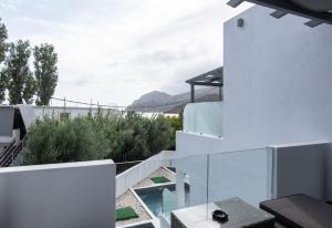 a white house with a view of the mountains at SKYROS BLUE SUITES in Skiros