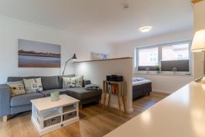 a living room with a couch and a table at Deichlamm in Sankt Peter-Ording