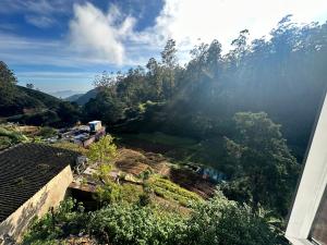 a view of a village with mountains and trees at Sushi guest - mini in Nuwara Eliya +19 photos