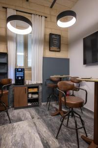 a bar with stools and a table in a room at Marea Boutique Hotels in Sliema