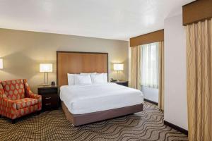 a hotel room with a bed and a chair at La Quinta by Wyndham Las Vegas RedRock/Summerlin in Las Vegas