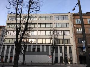 a large white building with trees in front of it at Studio 501 in Kaunas