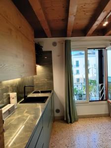 a kitchen with a sink and a window at Suite Latina - San Leonardo in Treviso