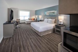 a large hotel room with a bed and a couch at Hyatt House Lewes Rehoboth Beach in Lewes