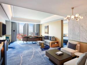 a hotel room with a living area with a view at Fairmont Ambassador Seoul in Seoul
