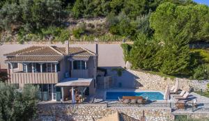 a villa with a swimming pool and a house at Meganisi Villas in Spartokhórion