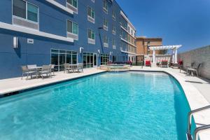 a swimming pool in front of a building at AmericInn by Wyndham San Angelo in San Angelo