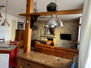a living room with a couch and a stone wall at Le Passage in Concarneau