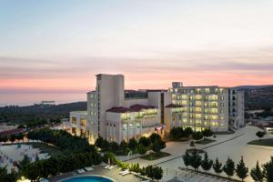 an aerial view of a hotel at dusk at Ramada Resort By Wyndham Kizkalesi in Kizkalesi