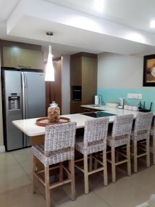 a kitchen with a table and chairs and a refrigerator at 163 Eden on the Bay in Big Bay +20 photos