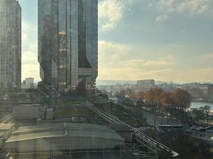 a view of a city with a tall building at Seine & Eiffel Flat Beaugrenelle Area in Paris