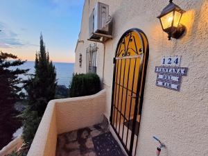 a door to a building with a sign on it at la ventana al mar in Jávea