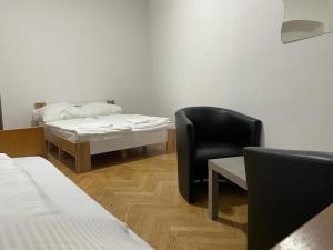 Zimmer mit einem Bett, einem Stuhl und einem Tisch in der Unterkunft easybook-in in Wien