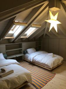 un dormitorio en el ático con 2 camas y una estrella en el techo en KATIKIA ZAGORI, en Vitsa