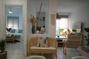 a living room with chairs and a room with a bed at Apartamento Balneario Beach in Tarifa