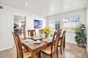 a dining room with a wooden table and chairs at Large Family Home - Only 20 mins from Disneyland in Fullerton