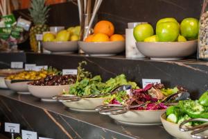 a display of bowls of fruits and vegetables on a shelf at Levor Hotel in Bursa