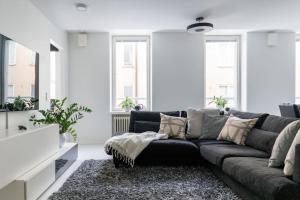 a living room with a couch in a white room at Spacious 1 BR with a central location in Helsinki