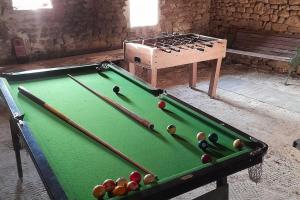 a room with a pool table and a wooden chest at Two Hoots - farmhouse with summer pool. in Châteauponsac