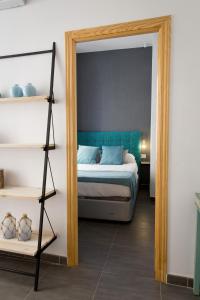 a bedroom with a bed and a mirror at Apartments Holidays2Malaga City Center in Málaga