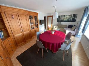 sala de estar con mesa roja y sillas en Ferienwohnung zur Alten Schmiede, en Lenzkirch