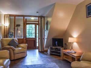 a living room with a couch and a tv at Lily Cottage - Uk40101 in Dunvant