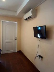 a room with a flat screen tv on the wall at Baan Kebsap บ้านเก็บทรัพย์ in Ko Yao Noi +45 photos