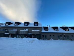 a building with snow on top of it at Kåvan Townhouse Funäsdalen in Funäsdalen