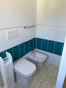 a bathroom with a toilet and a sink at Casa Tacconi in Villasimius