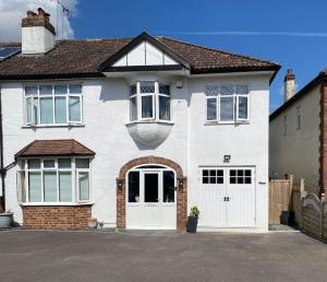 a white house with white doors and windows at The Annex, Bath Road, Saltford in Saltford