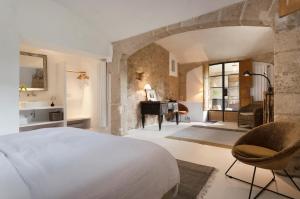 a bedroom with a large bed and a piano at Agroturismo Son Viscos in Valldemossa