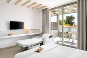 A television and/or entertainment centre at Cavo Delea Villas & Suites
