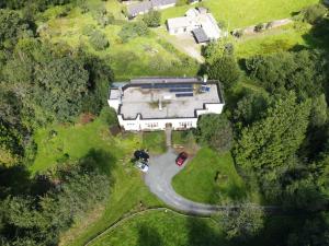 an aerial view of a large house with a driveway at Tranquil getaway near Brecon Beacons in Llandovery +9 photos