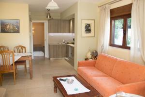 a living room with a couch and a table at Vouliagmeni Riviera Apartments in Athens