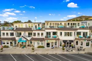 an aerial view of a building with a parking lot at Pier View Suites - Studio A in Cayucos