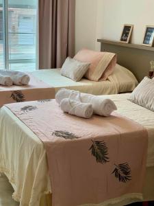 Duas camas com toalhas num quarto em Departamentos Fleming, luminosos p hasta 4 personas em Paraná