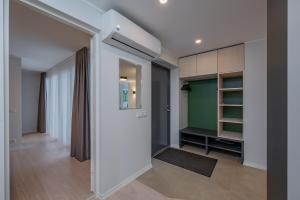 a room with a hallway with a door and a closet at Kalda Villa 