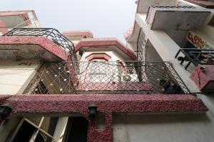 a dog sitting on a balcony of a building at Hotel Classic in Lucknow